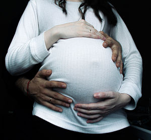 Rear view of woman holding hands