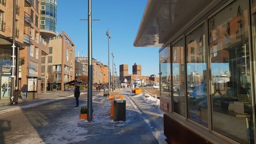 Street amidst buildings in city against sky