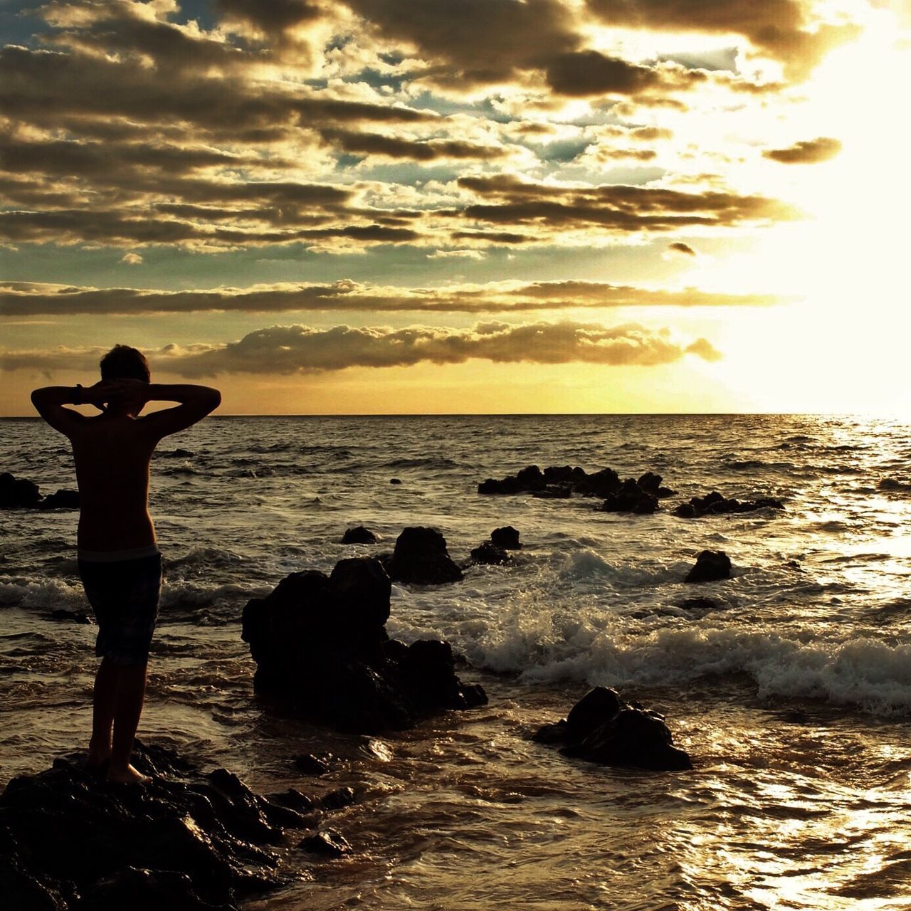 sea, water, horizon over water, beach, sunset, sky, leisure activity, lifestyles, scenics, silhouette, shore, tranquil scene, beauty in nature, standing, men, tranquility, vacations, nature