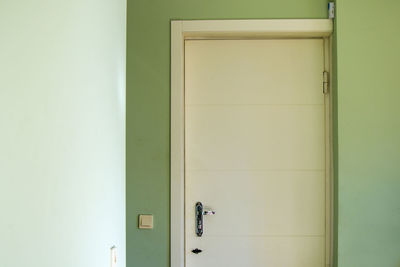 Closed door of green wall