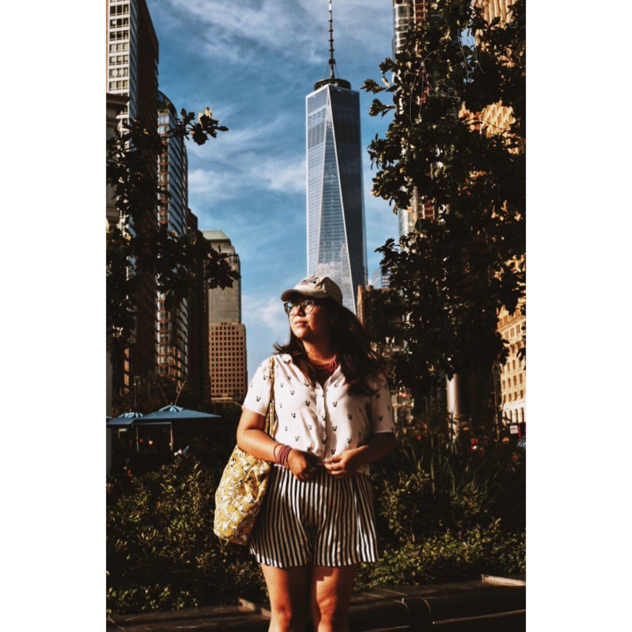 YOUNG WOMAN STANDING IN CITY