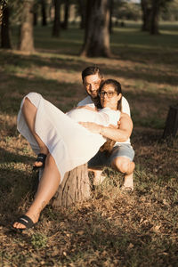 Side view of woman sitting on field