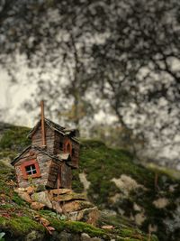 Low angle view of small house on field against sky