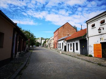 Empty alley amidst buildings in city