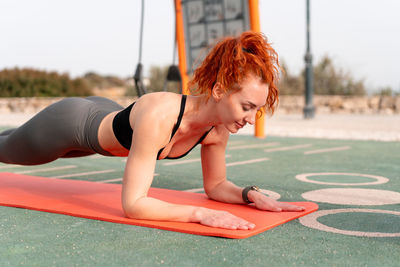 Portrait of young woman exercising in gym