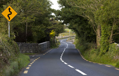 Road sign by trees