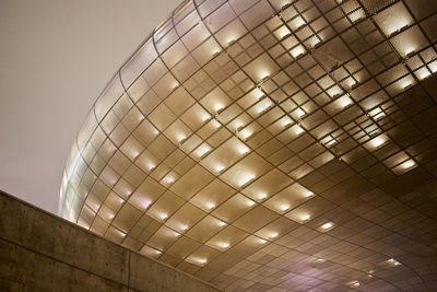 Low angle view of illuminated ceiling against building