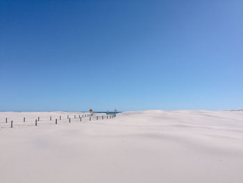 Scenic view of desert against clear blue sky