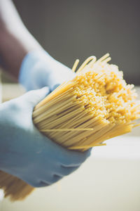 Cropped image of person making spaghetti
