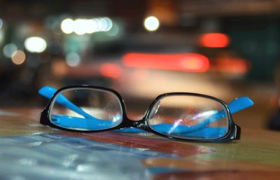 Close-up of sunglasses on glass table