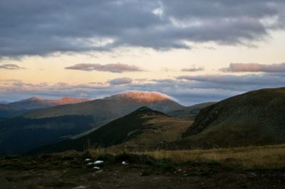 Countryside landscape against mountain range