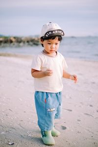 Portrait of boy standing at beach