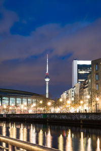 Illuminated buildings in city at waterfront