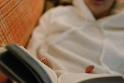 Midsection of woman reading book