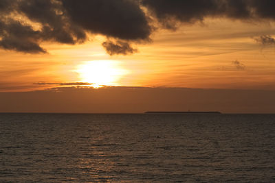 Scenic view of sea against romantic sky at sunset