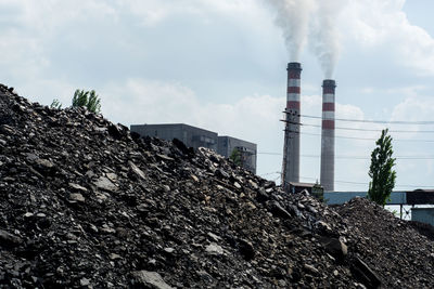 Low angle view of smoke stack against sky