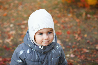 Portrait of cute smiling little baby girl on autumn orange background.