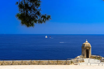 Scenic view of sea against clear blue sky