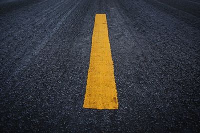 Yellow arrow symbol on road in city