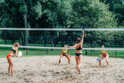 Beach tennis players at the net