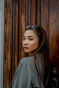 Side view portrait of young woman at home