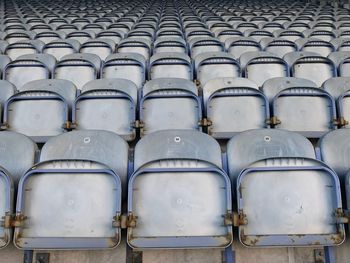 Full frame shot of empty folded chairs in stadium