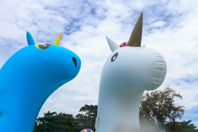 Close-up of sculpture against blue sky