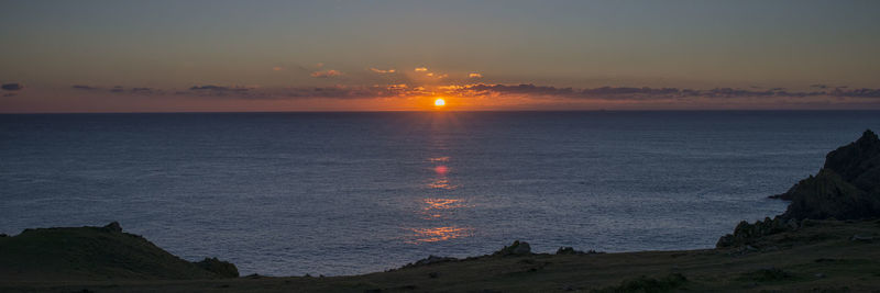 Scenic view of sea against sky at sunset