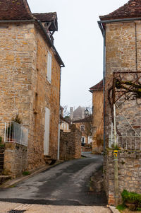 Street amidst buildings against sky