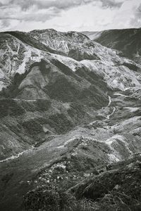 Scenic view of sea and mountains against sky