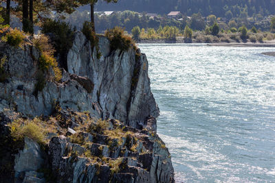 Rock formations by sea against sky