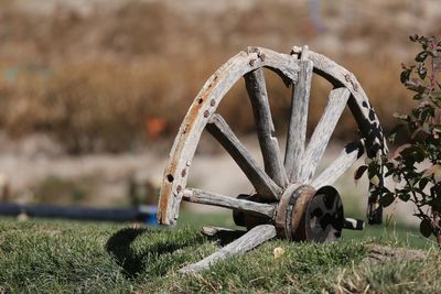 Close-up of abandoned wheel on field