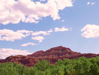 Scenic view of mountains against blue sky