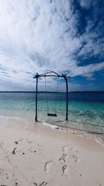 Lifeguard hut on beach against sky