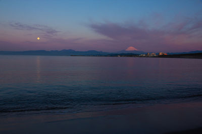 Scenic view of sea against romantic sky at sunset