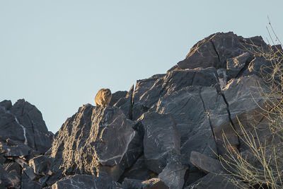 Rocks on mountain against clear sky