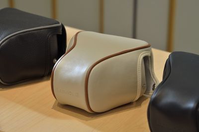 Close-up of leather camera case on table