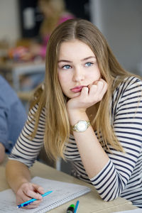 Portrait of bored teenage girl in classroom
