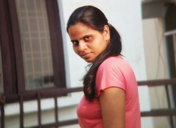 Portrait of woman standing at home