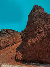 Rock formations on mountain against clear blue sky