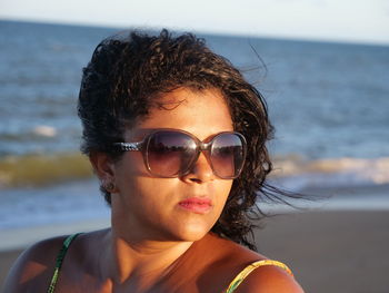 Portrait of man wearing sunglasses at beach