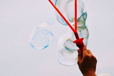 Close-up of hand holding ice cream against blurred background