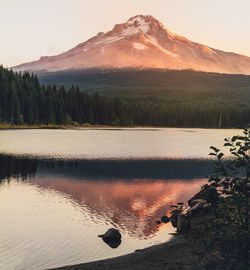 Scenic view of lake by mountains against sky