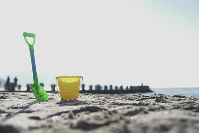 Close-up of yellow sand on beach against clear sky