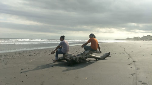 Rear view of men on beach