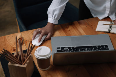 High angle view of man using laptop on table