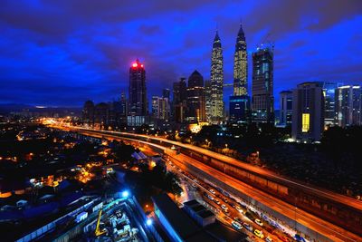 Illuminated city against sky at night