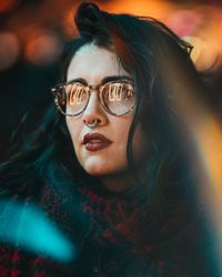 Close-up portrait of young woman in sunglasses