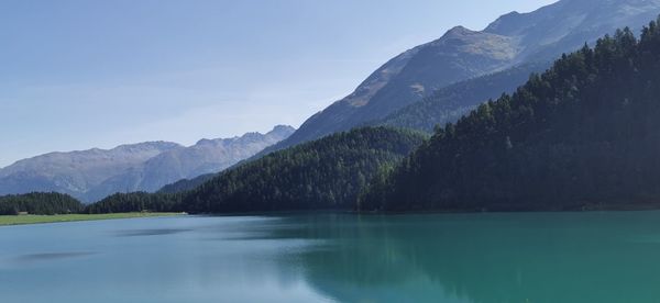 Scenic view of lake and mountains against sky