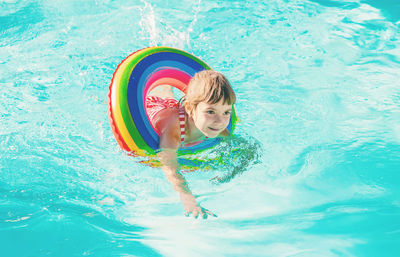 Smiling girl swimming in pool